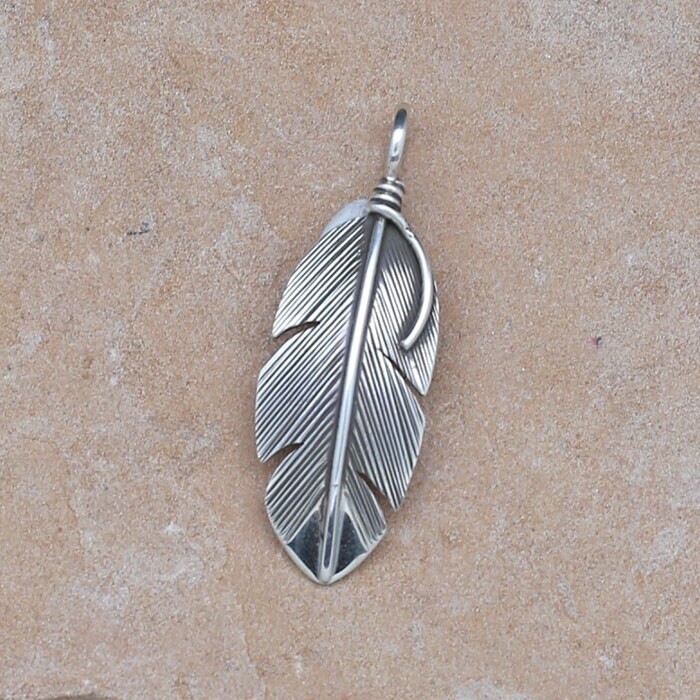 Small curved feather pendant