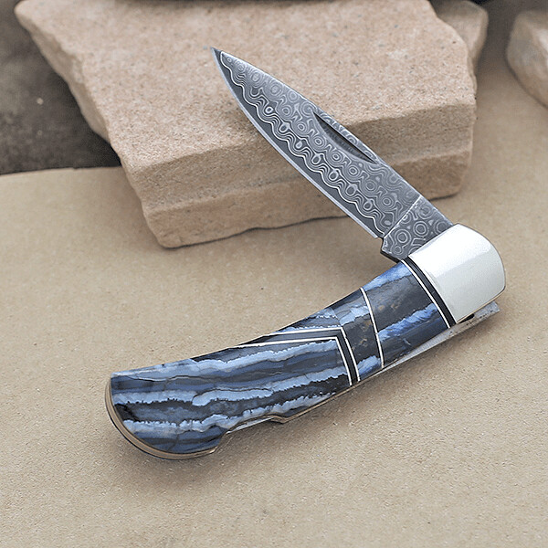 Custom pocket knife w/ mineralized tooth inlay