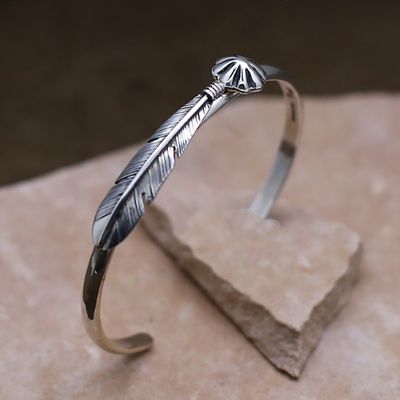 Thin feather bracelet w/ concho design