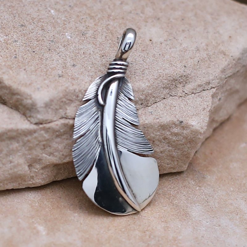 Large curved feather pendant designed by artist Lena Platero