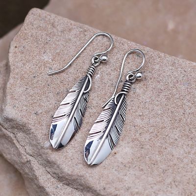 Feather dangle earrings designed by artist Lena Platero
