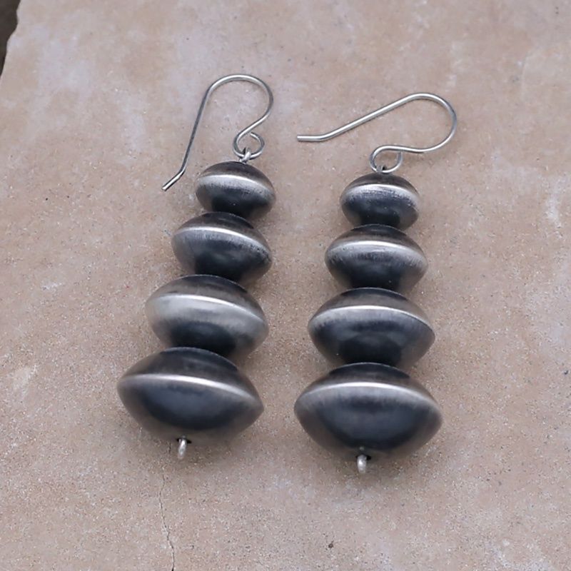 Graduated saucer style silver bead earrings