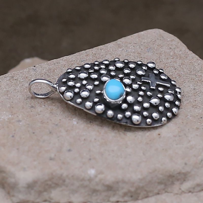 Tear drop shaped pendant designed by artist Akee Douglas