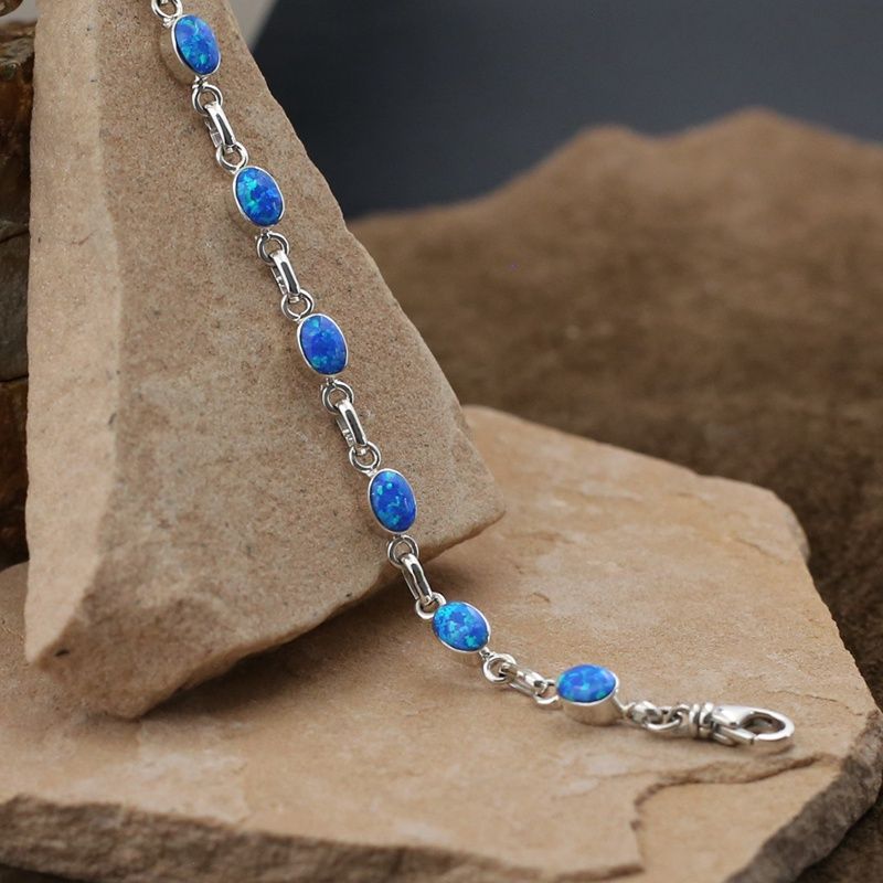 Small oval link bracelet w/ blue cultured opal