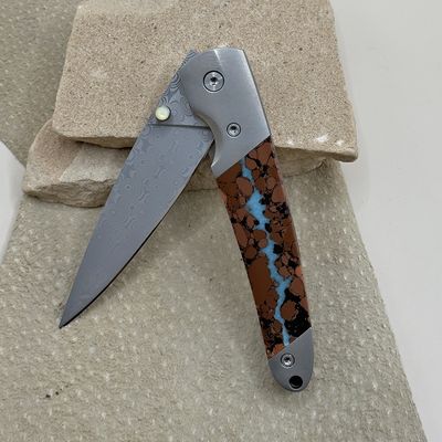 Damascus folding knife with boulder turquoise inlay