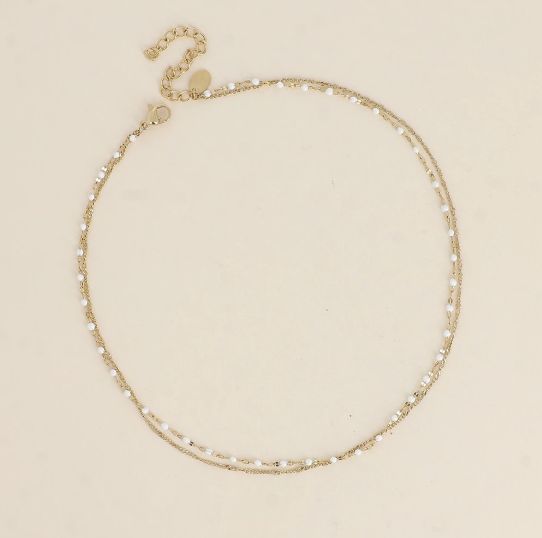 Bracelet/ras de cou en acier doré et détails blancs