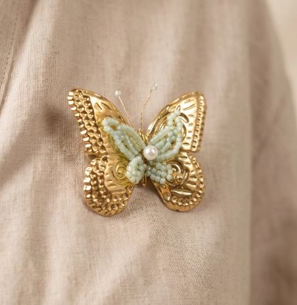 Broche "Papillon" en acier doré avec perles bleu