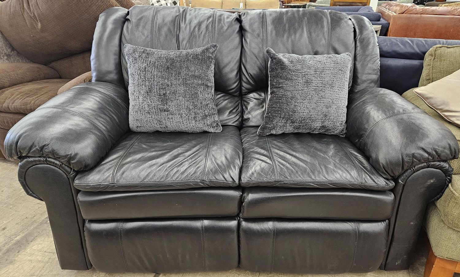 Black Leather Self-Reclining Loveseat
