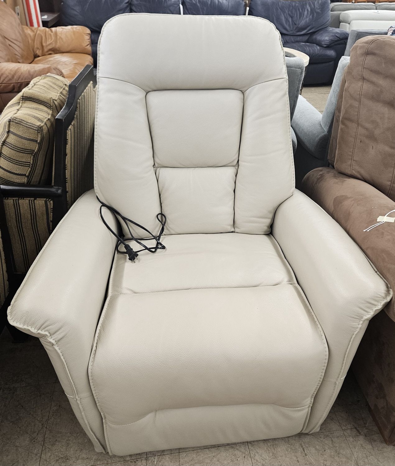Cream leather swivel, recliner, and lift chair