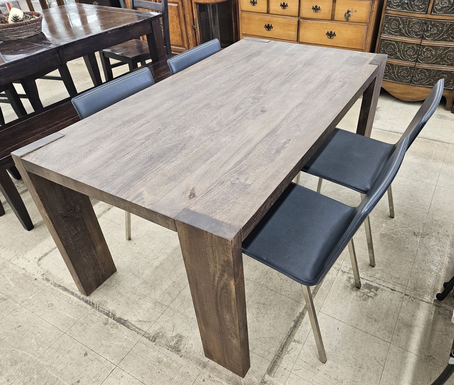 Modern and stylish CB2 Blox Rectangular Brown Wood Dining Table with four chairs