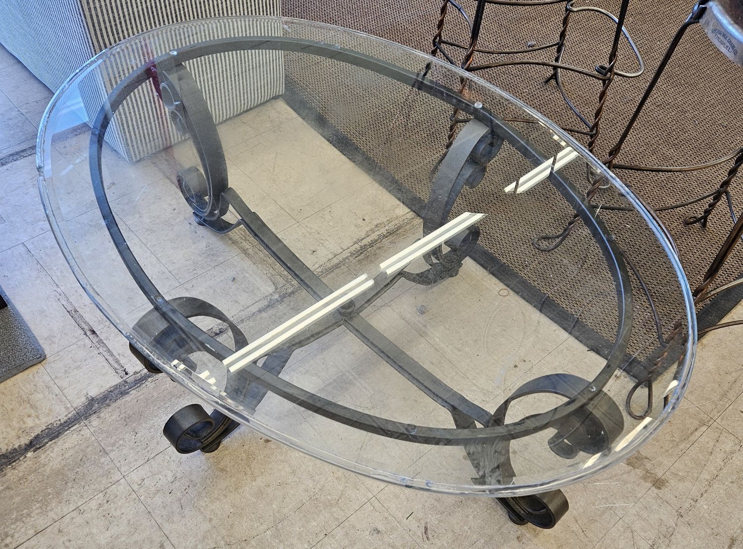 Oval-shaped glass and iron coffee table