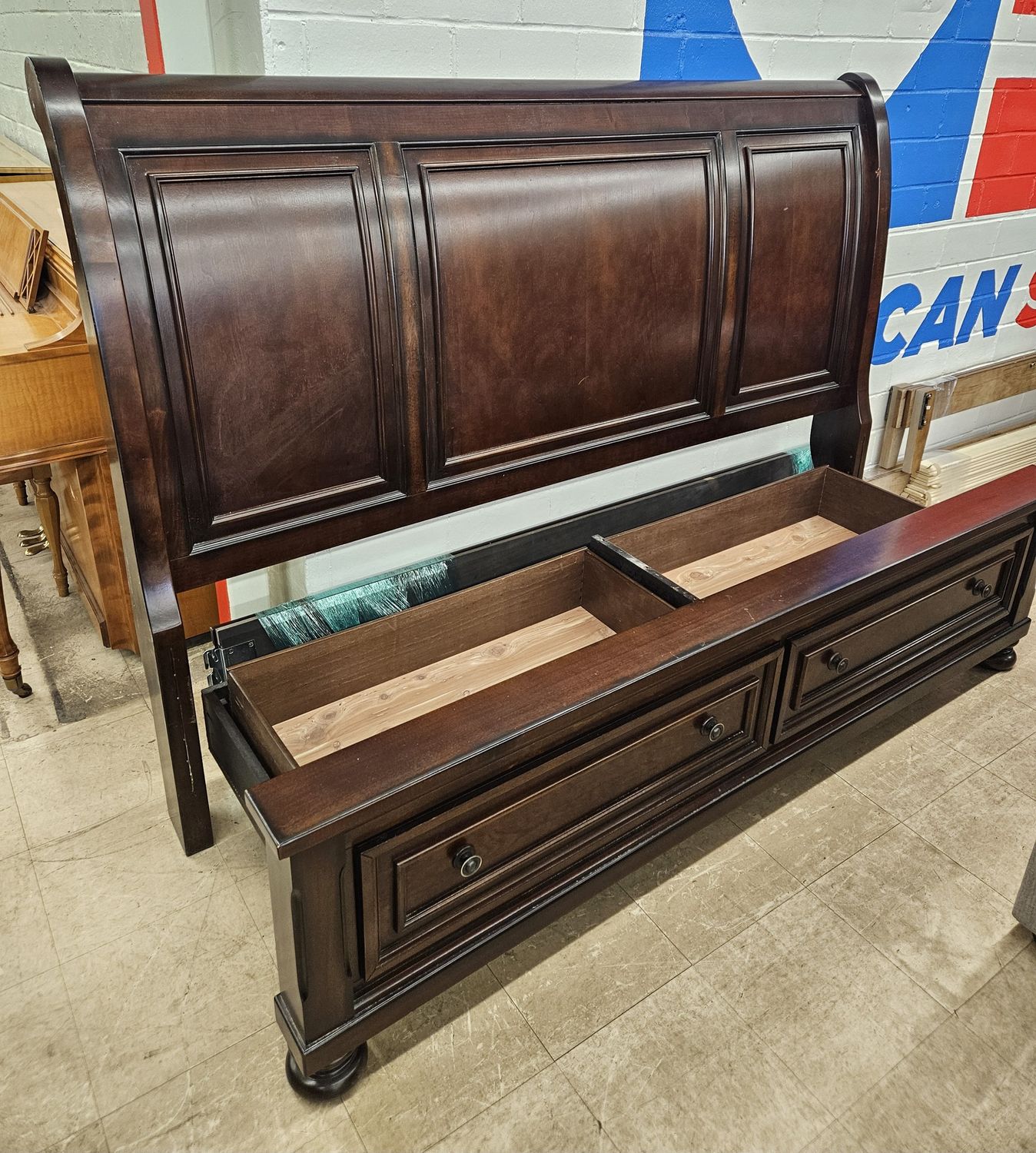 Dark brown wooden sleigh bed
