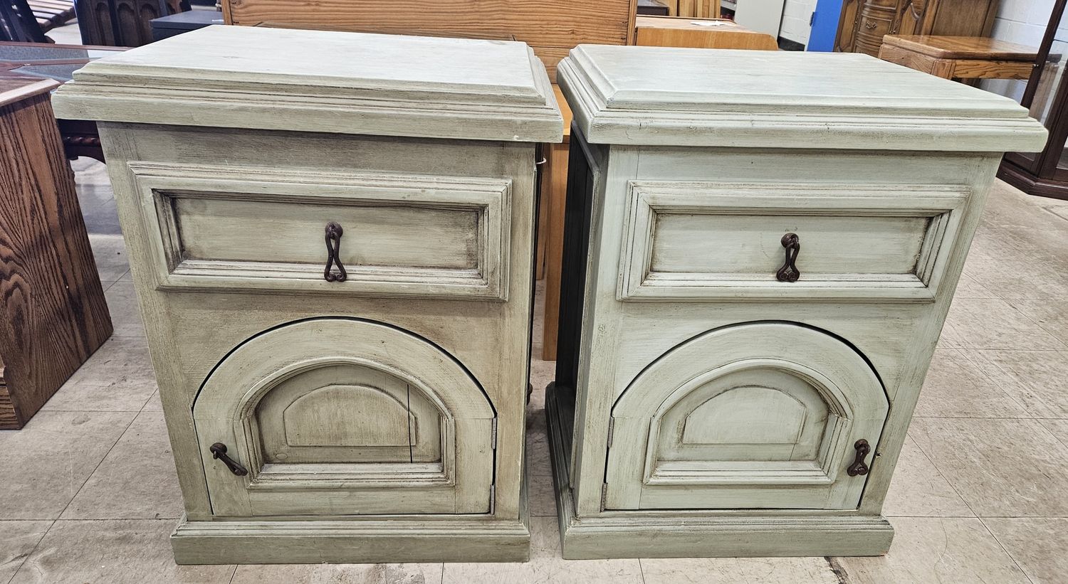 A pair of rustic French-style bedside tables