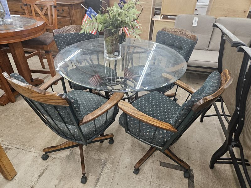 Glass table with 4 green chairs