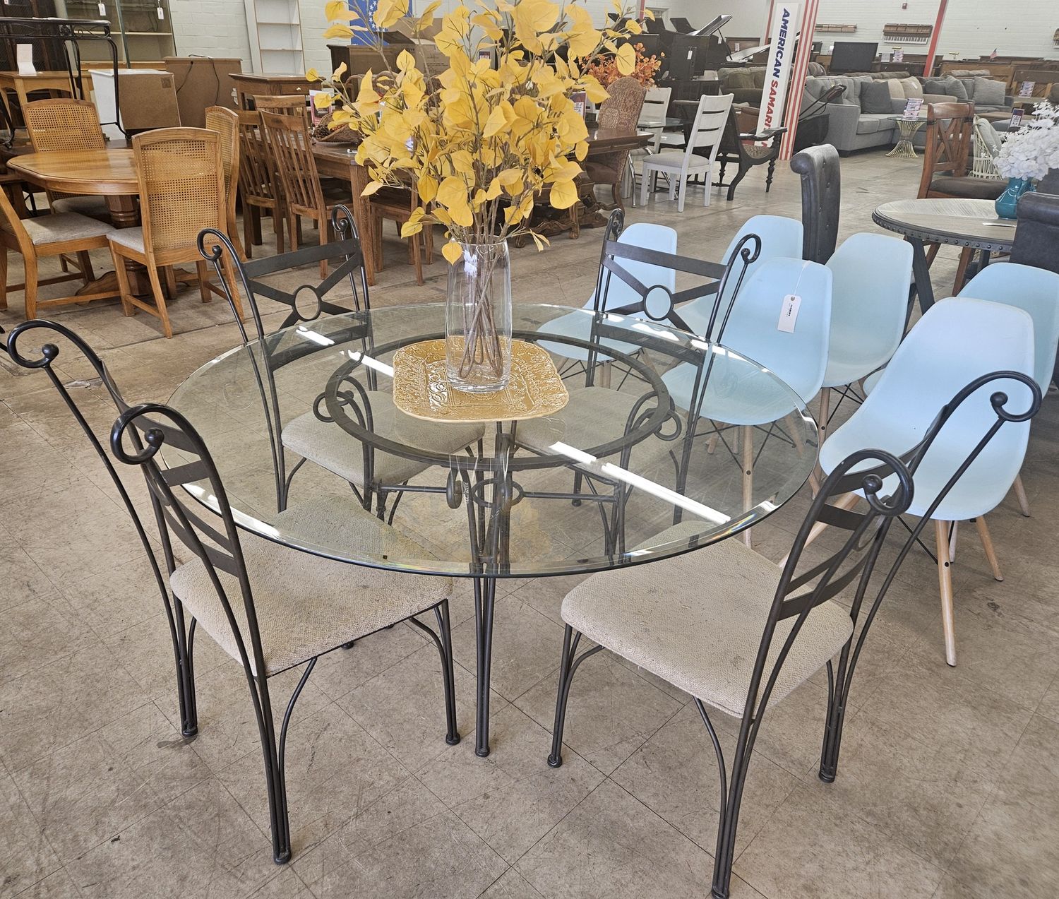 Dining set features a round glass tabletop and four chairs