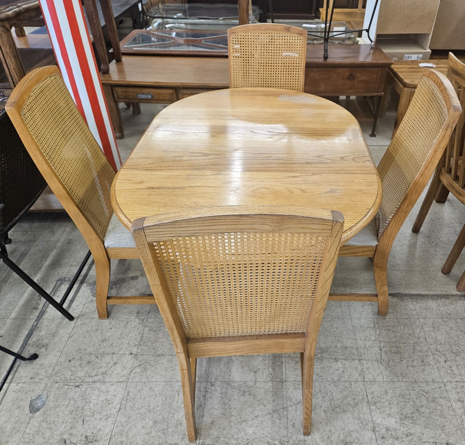 Solid wood dining set featuring an oval table and four chairs