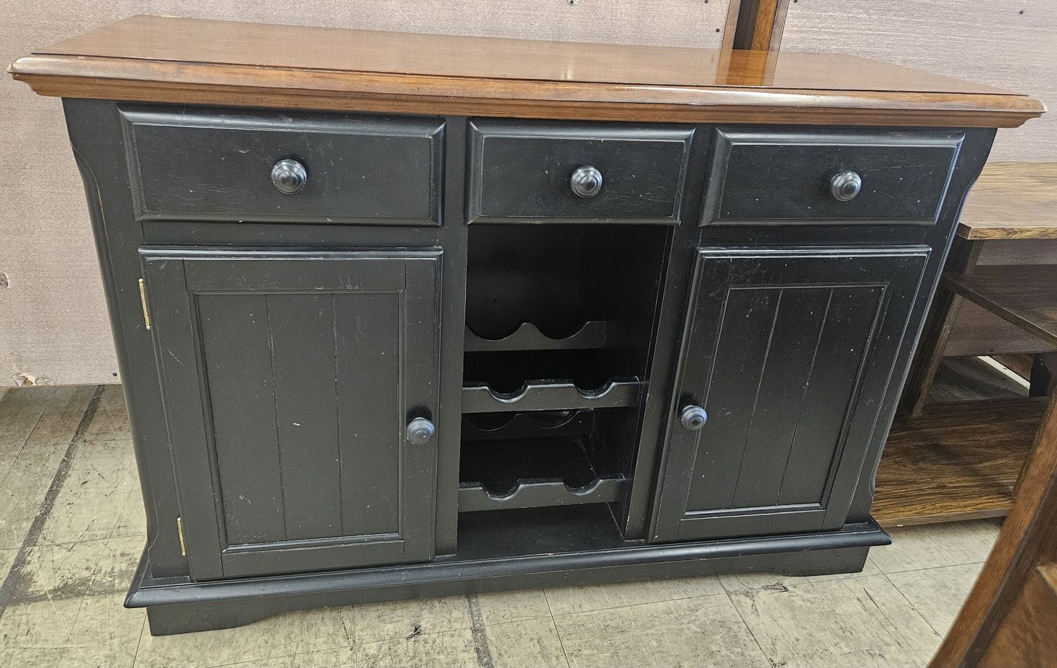 Black wood buffet with integrated wine storage.