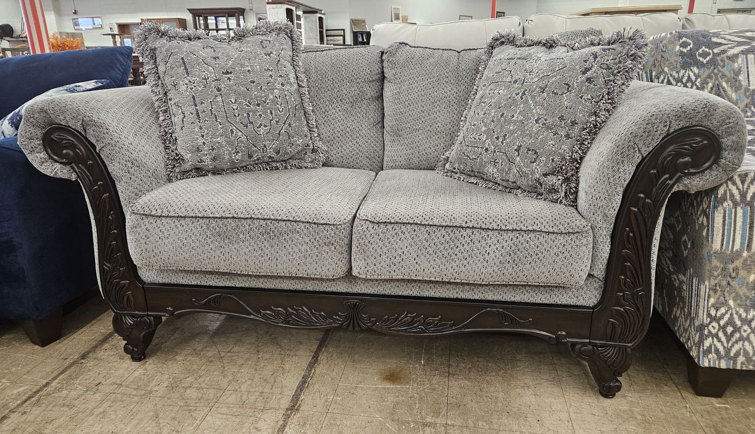 Elegant carved wood loveseat.