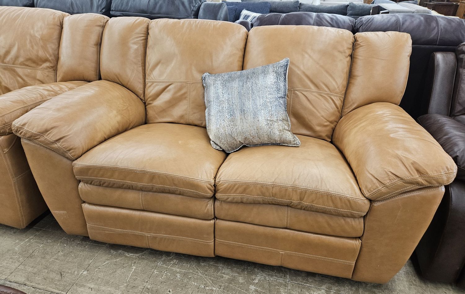 Tan Leather Reclining Loveseat.