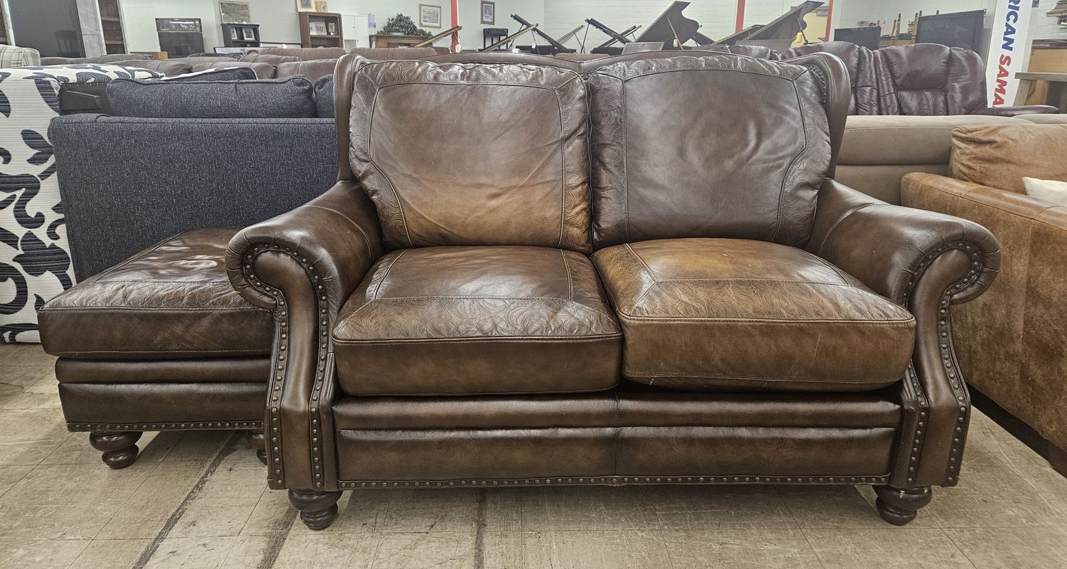 Luxurious brown leather loveseat with matching ottoman