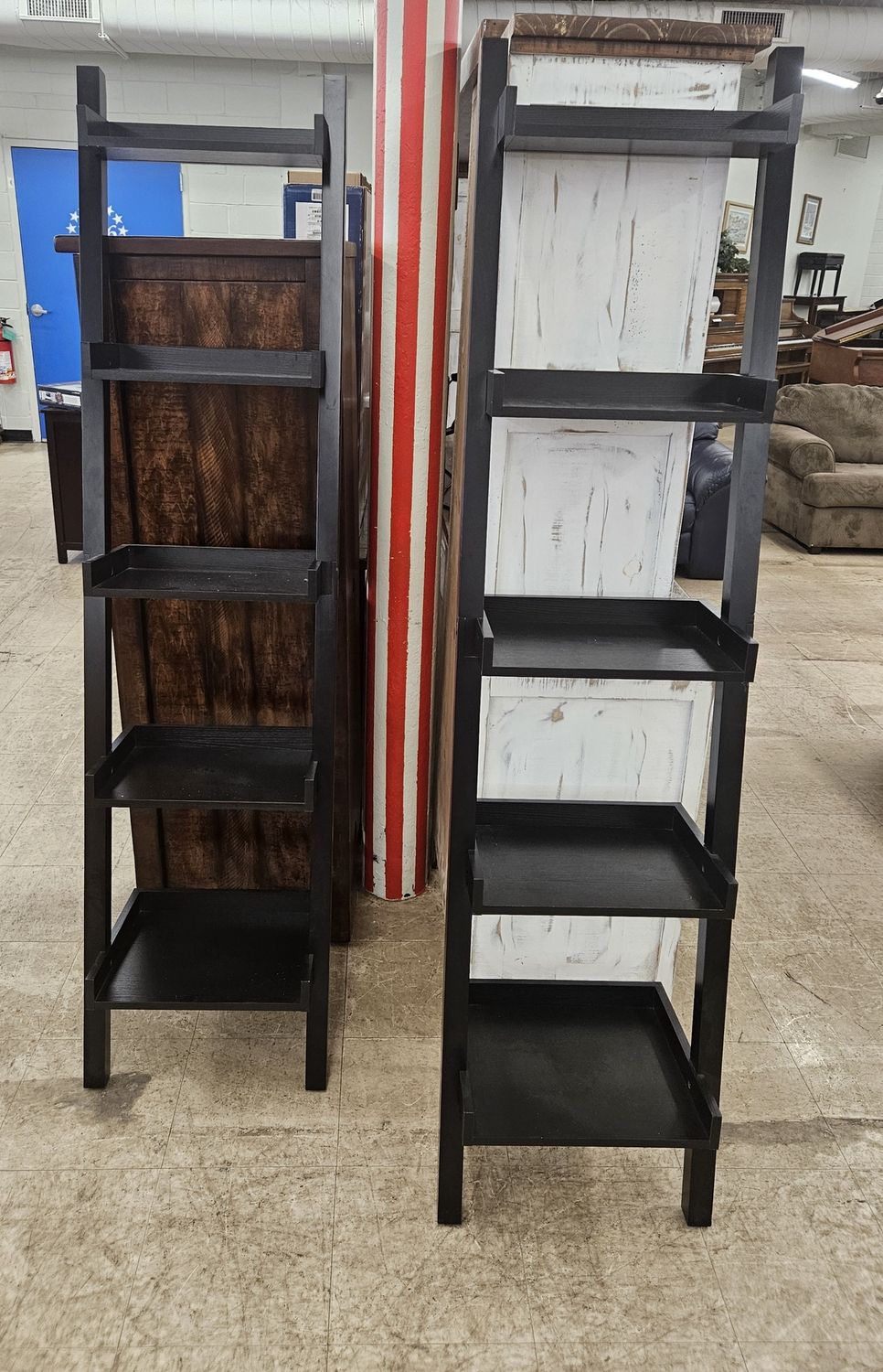 Pair of black ladder-style display shelves