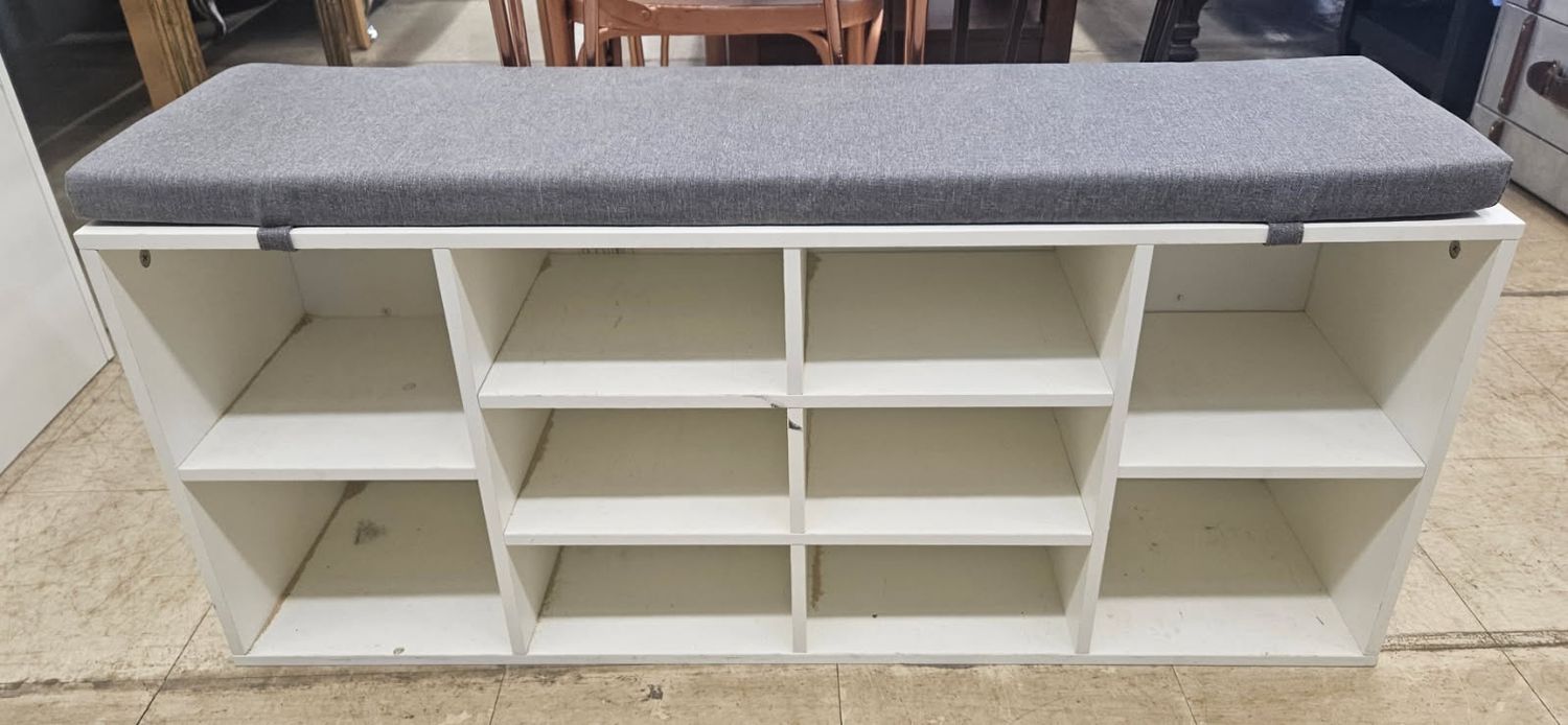 white storage bench with a sleek gray cushion top
