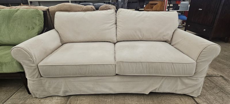 Cream slipcovered loveseat