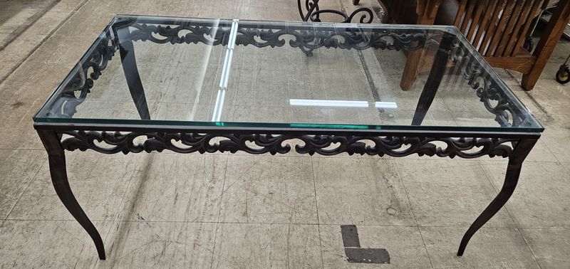 Ornate wrought iron and glass table.