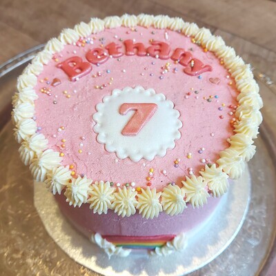 Pink birthday cake with rainbow