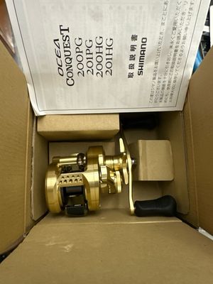 Shimano Ocea Conquest 200PG. Gorgeous Round Baitcast Reel. 11/2 BB, 4.8:1, 17.6lb Drag. New In Box.