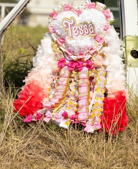 Elite Heart Shape Senior Mum in Hot Pink, White, and Gold Featuring an Ombre Pink to Light Pink to Dark Pink Boa and Barbie Font for Homecoming
