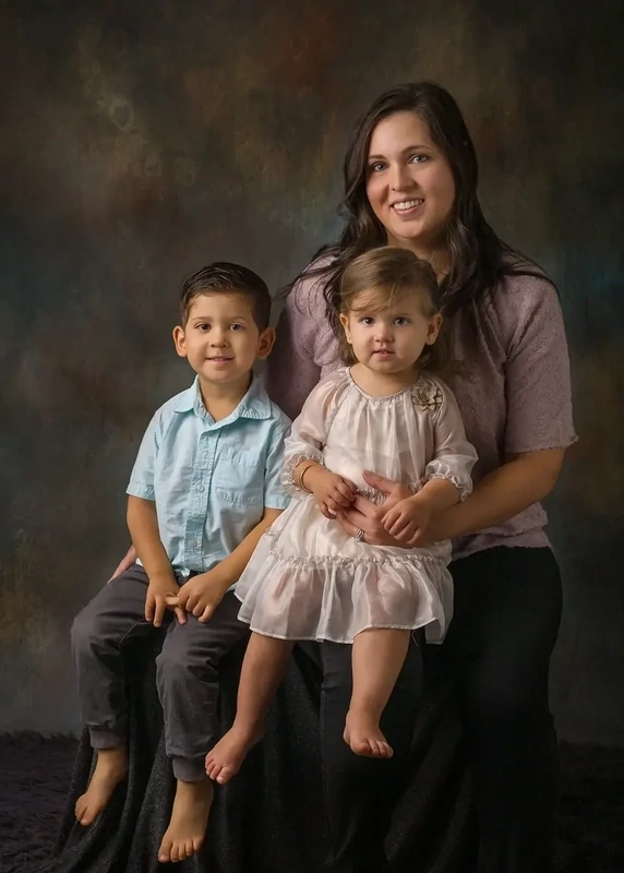 Modern portrait of young mom with her toddler boy and girl