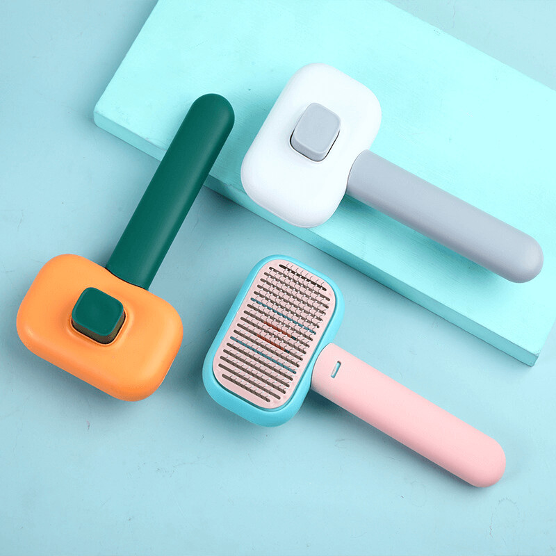 Self cleaning at hair brush for long hair in colours green - orange, pink - blue, grey - white.