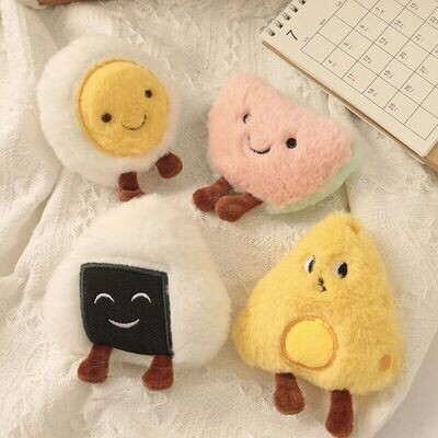Top view of small cat plush toys in the shape of a poached egg, watermelon, rice ball and cheese