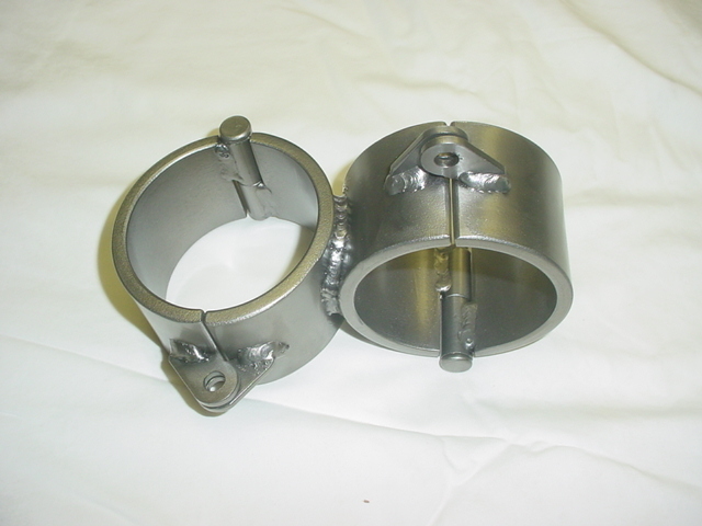Close-up of X-Cuffs Complete restraint showing single welded cuff set with rigid crossed shackle design.