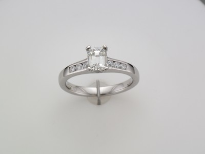 18 carat white gold emerald cut diamond ring with diamond set shoulders