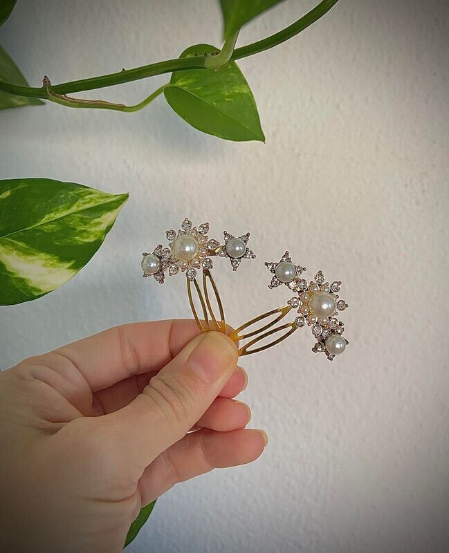 Pack de 2 horquillas de estrellas de unos 4 cm cada una en base dorada formadas por cristales transparentes y perlas.

Perfectas para adornar trenzas, recogidos bajos o semirecogidos ya que aportan un toque de luminosidad al peinado.