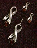 PENDANT - STERLING SILVER RIBBON WITH RUBY