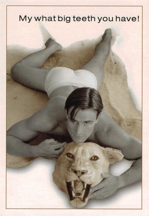 GUY LAYING ON ANIMAL RUG, MY WHAT BIG TEETH YOU HAVE!