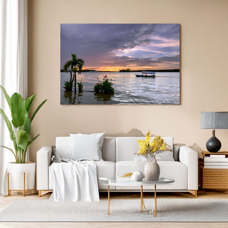 Canvas print of tropical sunset with palm trees and boat displayed in cozy living room