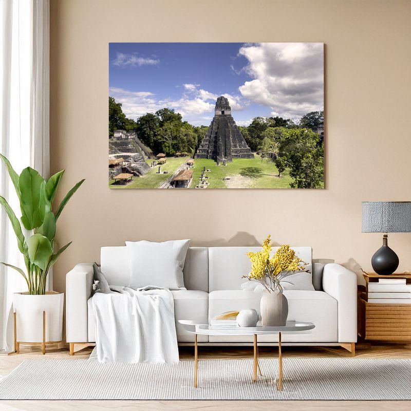 Canvas print of Tikal pyramid and plaza under blue sky displayed in modern living room