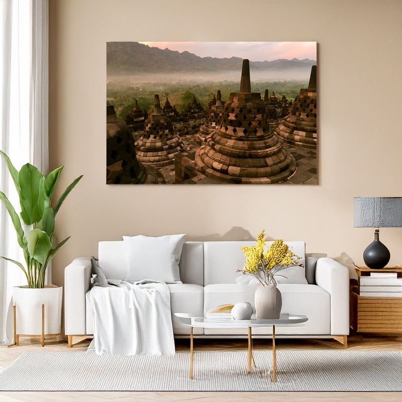 Canvas print of Borobudur stupas in misty dawn light adding serene charm to the living room
