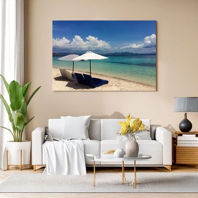 Canvas print of tropical beach with white loungers and umbrellas for relaxing living room vibe