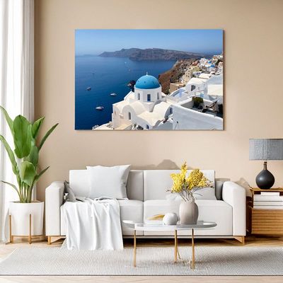 Canvas print of blue-domed Santorini church with sea and boats for elegant room styling
