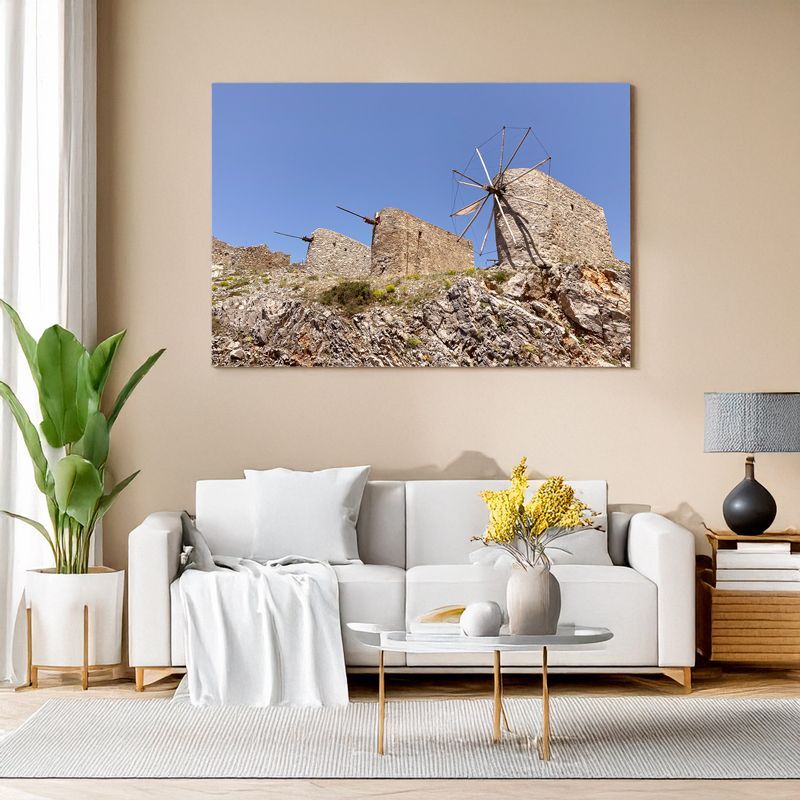Canvas print of historic stone windmills on rocky hill for rustic Mediterranean decor