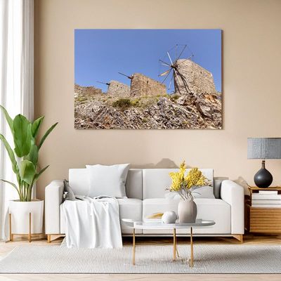 Canvas print of historic stone windmills on rocky hill for rustic Mediterranean decor