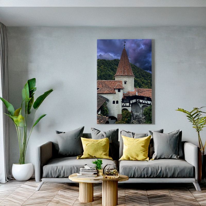 Bran Castle tower wall art in modern room with grey sofa and yellow pillows.