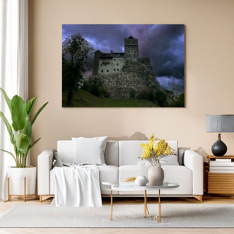 Bran Castle wall art in living room with dramatic cloudy sky above medieval fortress.