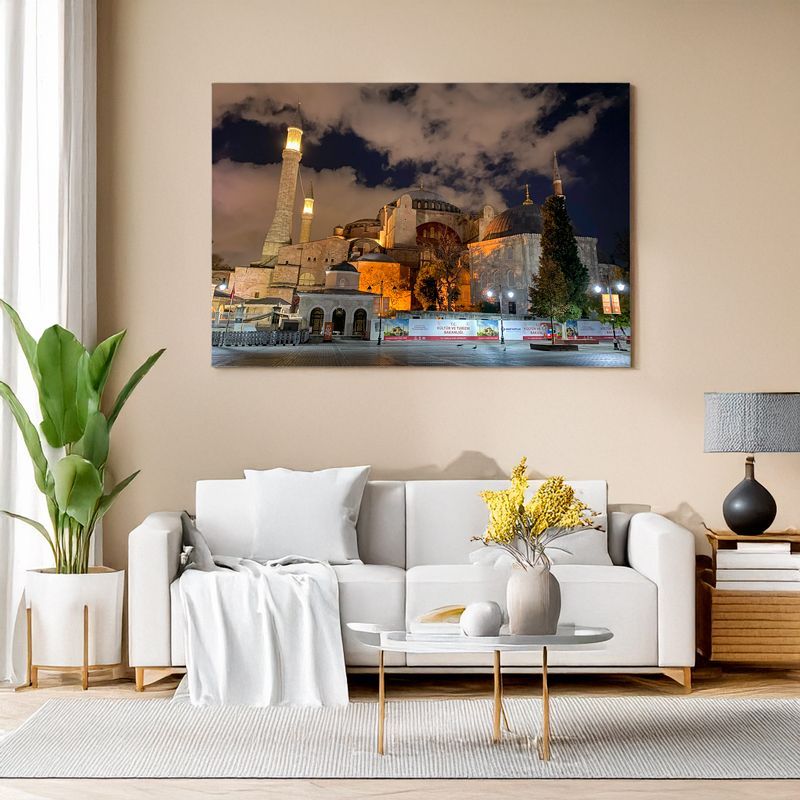 Wall art above a white sofa shows Hagia Sophia in Istanbul at night, warmly illuminated with a dramatic cloudy sky.