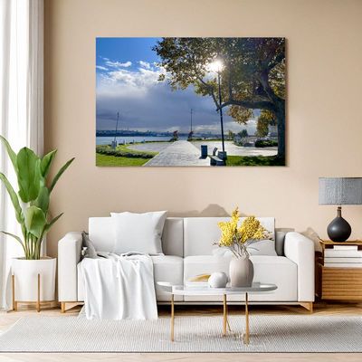 Wall art in a bright living room featuring a sunny photo of a park path in Istanbul with a view of the Bosphorus and a bright